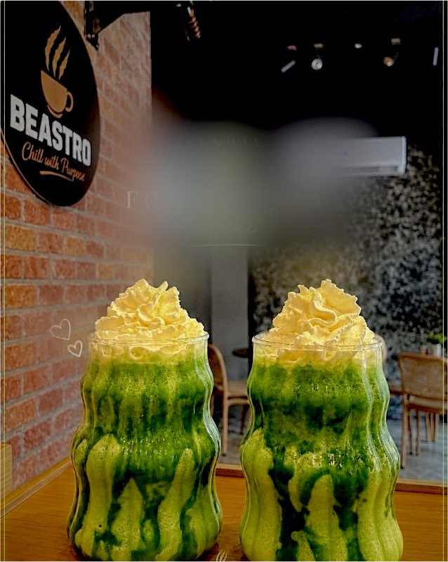 Two blended matcha drinks topped with whipped cream