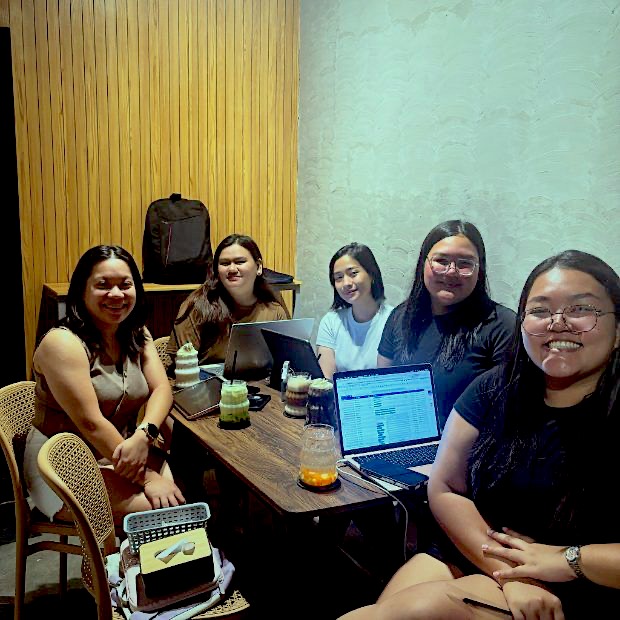 Friends working on laptops over iced drinks