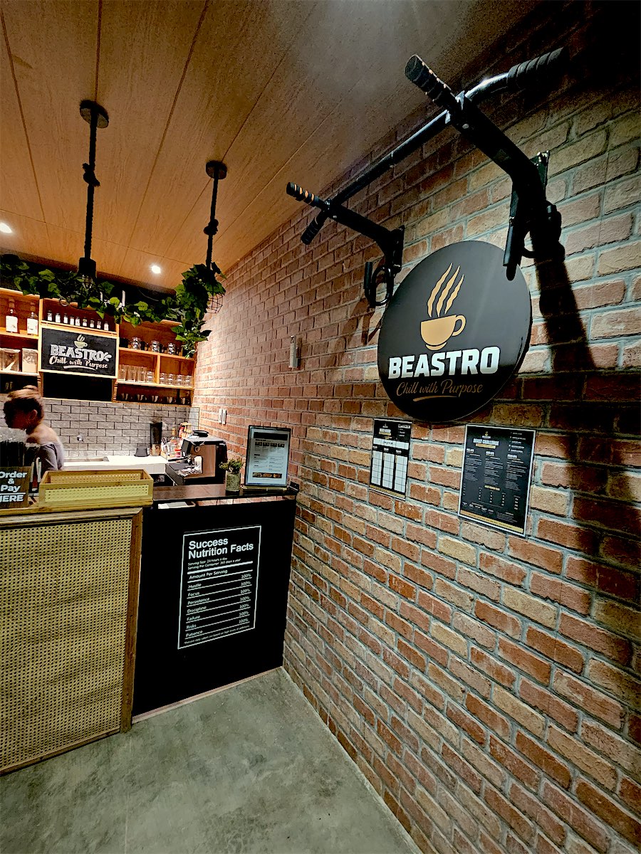 Red brick wall with the pull-up bar and the round Beastro sign